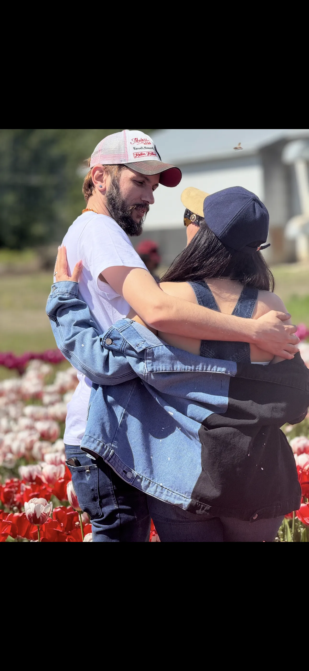 A couple embracing in a flower field